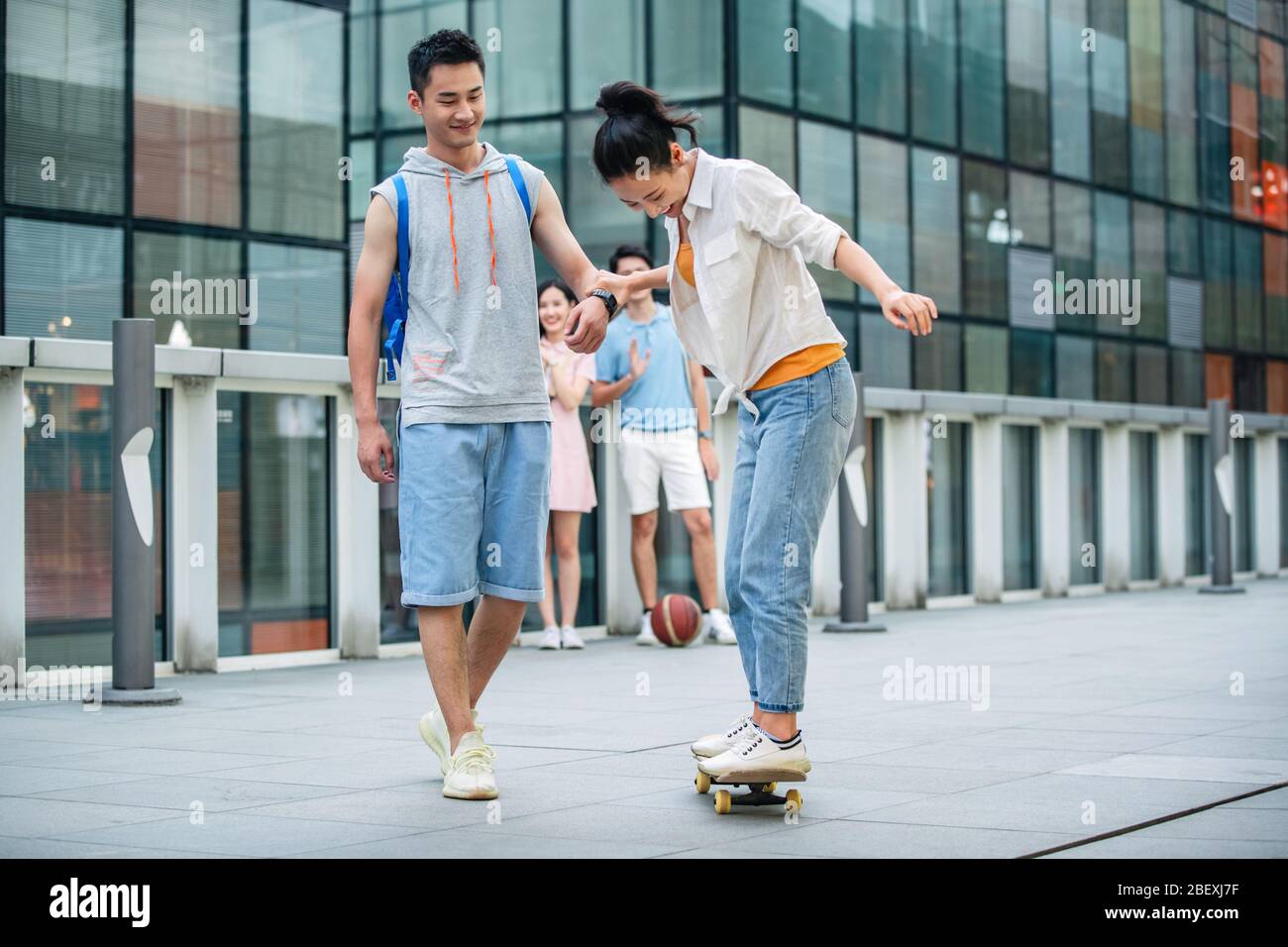 Handsome students goddaughter friend skateboarding Stock Photo
