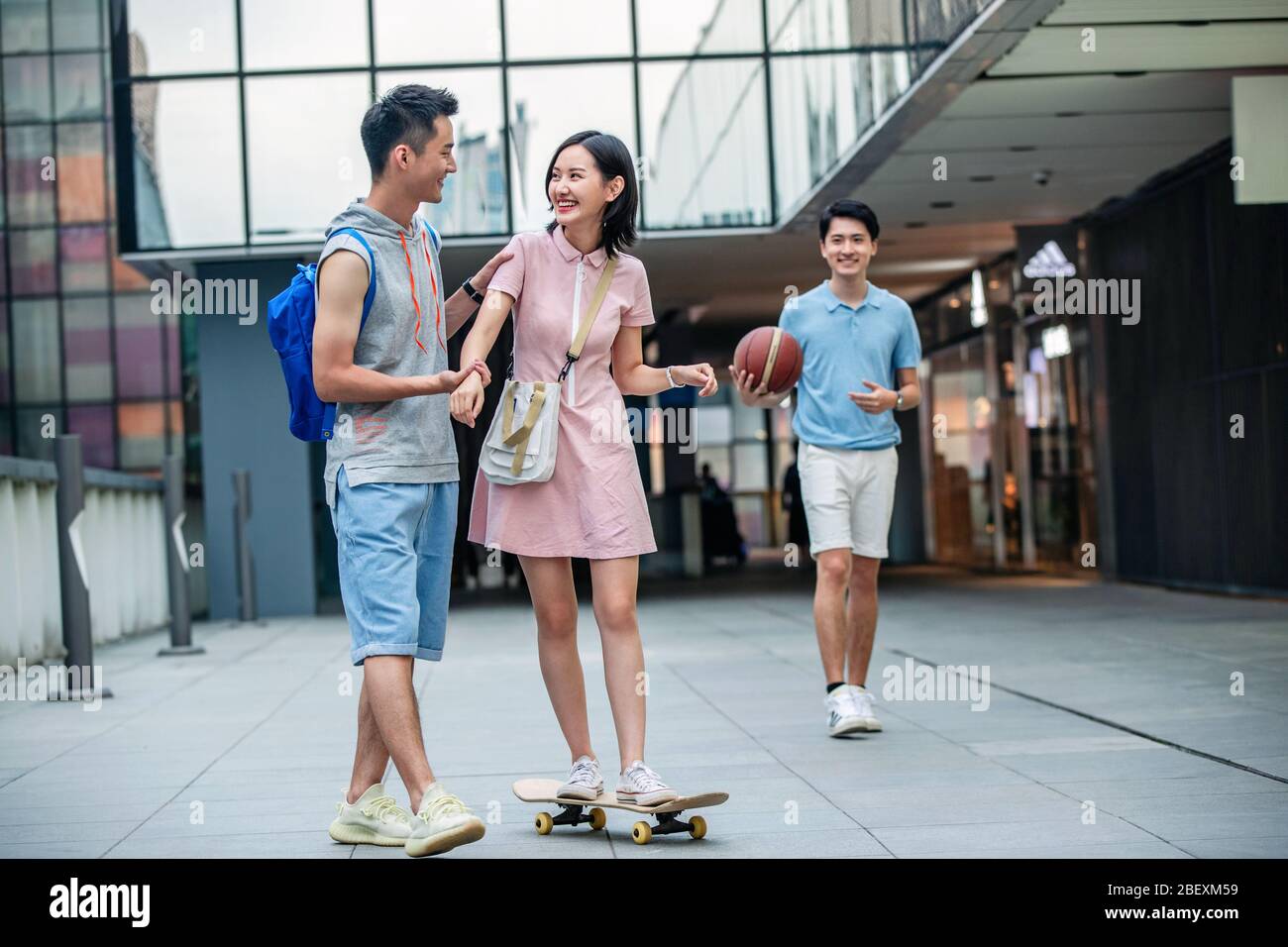 Handsome students goddaughter friend skateboarding Stock Photo