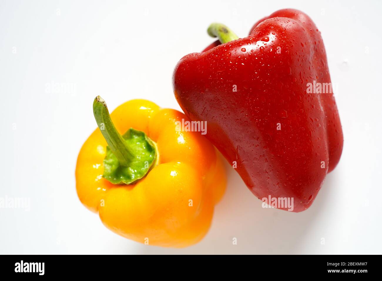 A whole red and yellow pepper on a plain white background Stock Photo ...