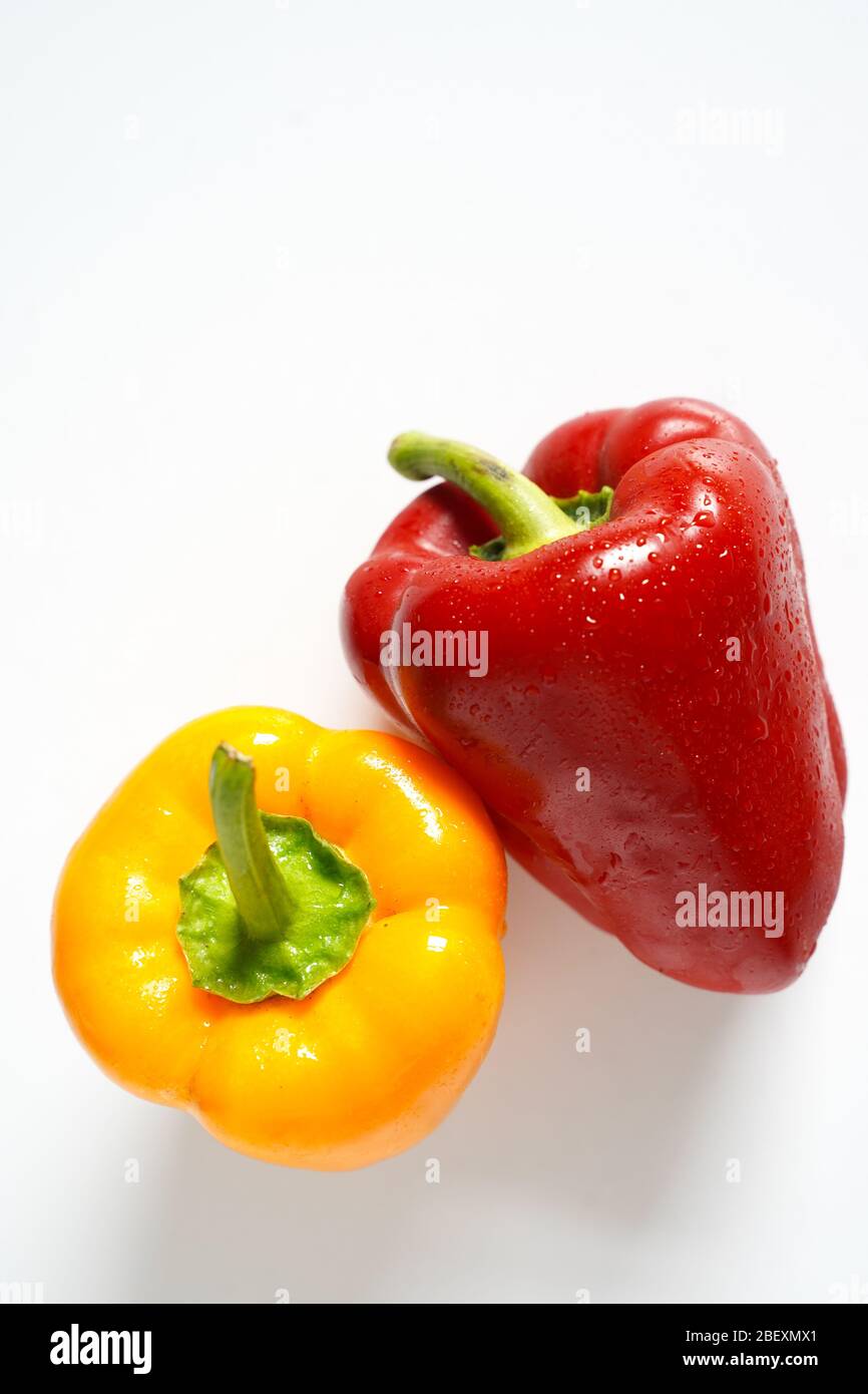 A whole red and yellow pepper on a plain white background Stock Photo ...
