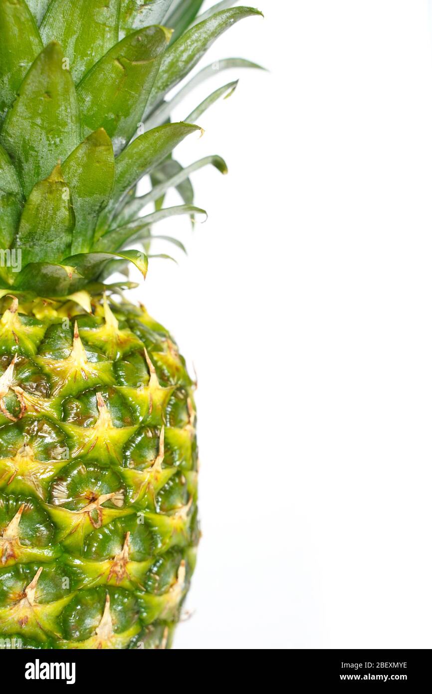 A whole pineapple against a plain white background Stock Photo