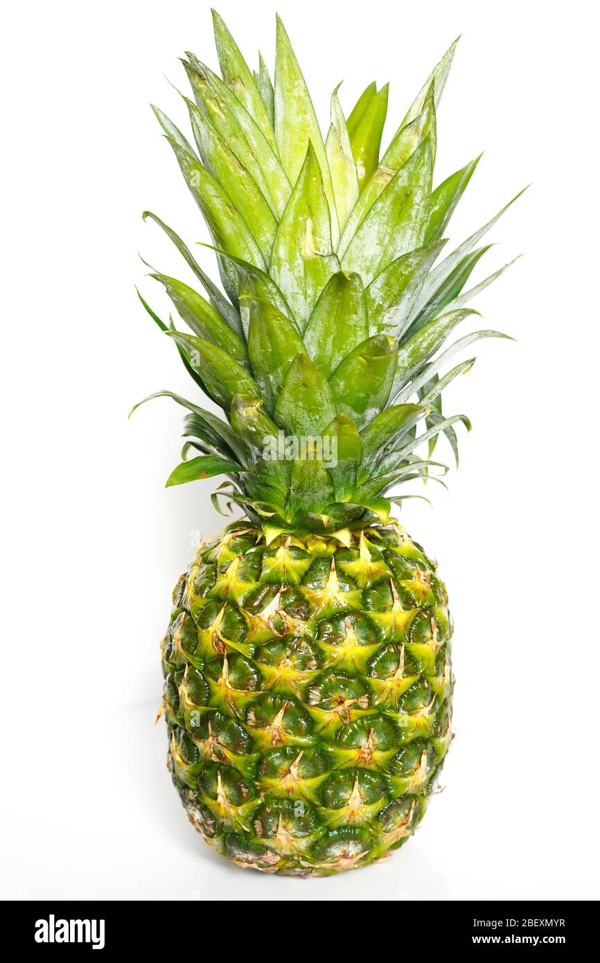 A whole pineapple against a plain white background Stock Photo
