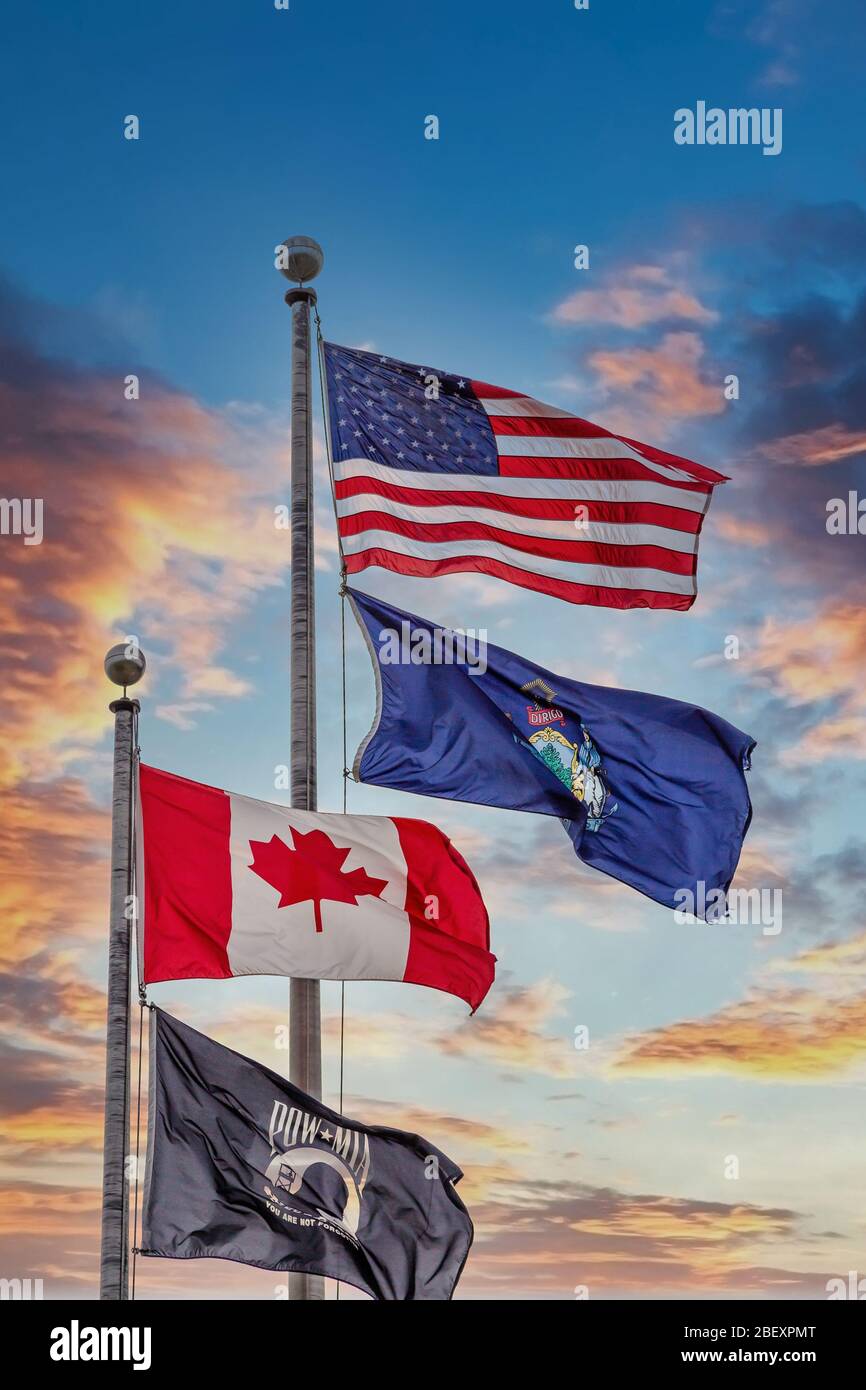 American Maine Canadian and POW Flags at Sunset Stock Photo