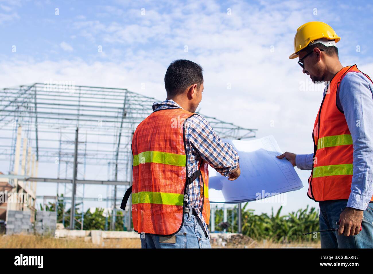 Engineer or inspector checking progressing work in construction site Stock Photo