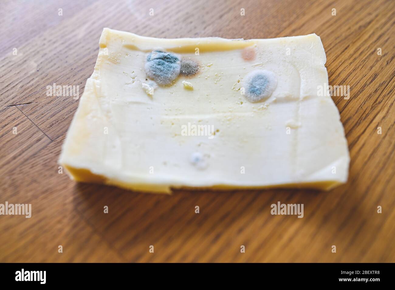 cheese with past expiration date on kitchen table Stock Photo Alamy