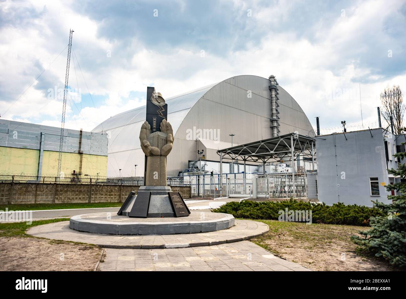 Chernobyl nuclear power plant with shelter and monument in memory of disaster. Kiev region, Ukraine Stock Photo
