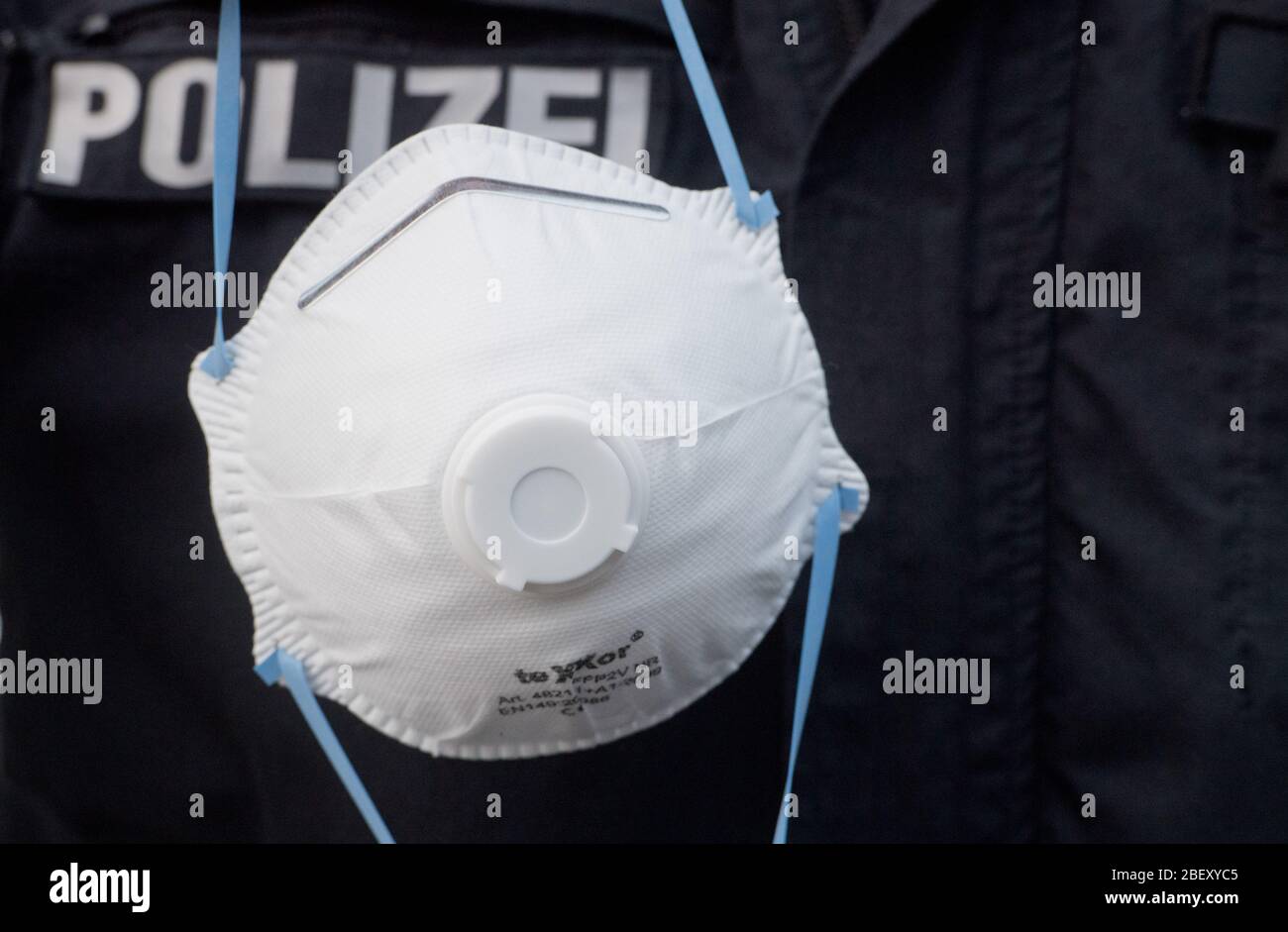 Stralsund, Germany. 16th Mar, 2020. A policeman shows a respirator of