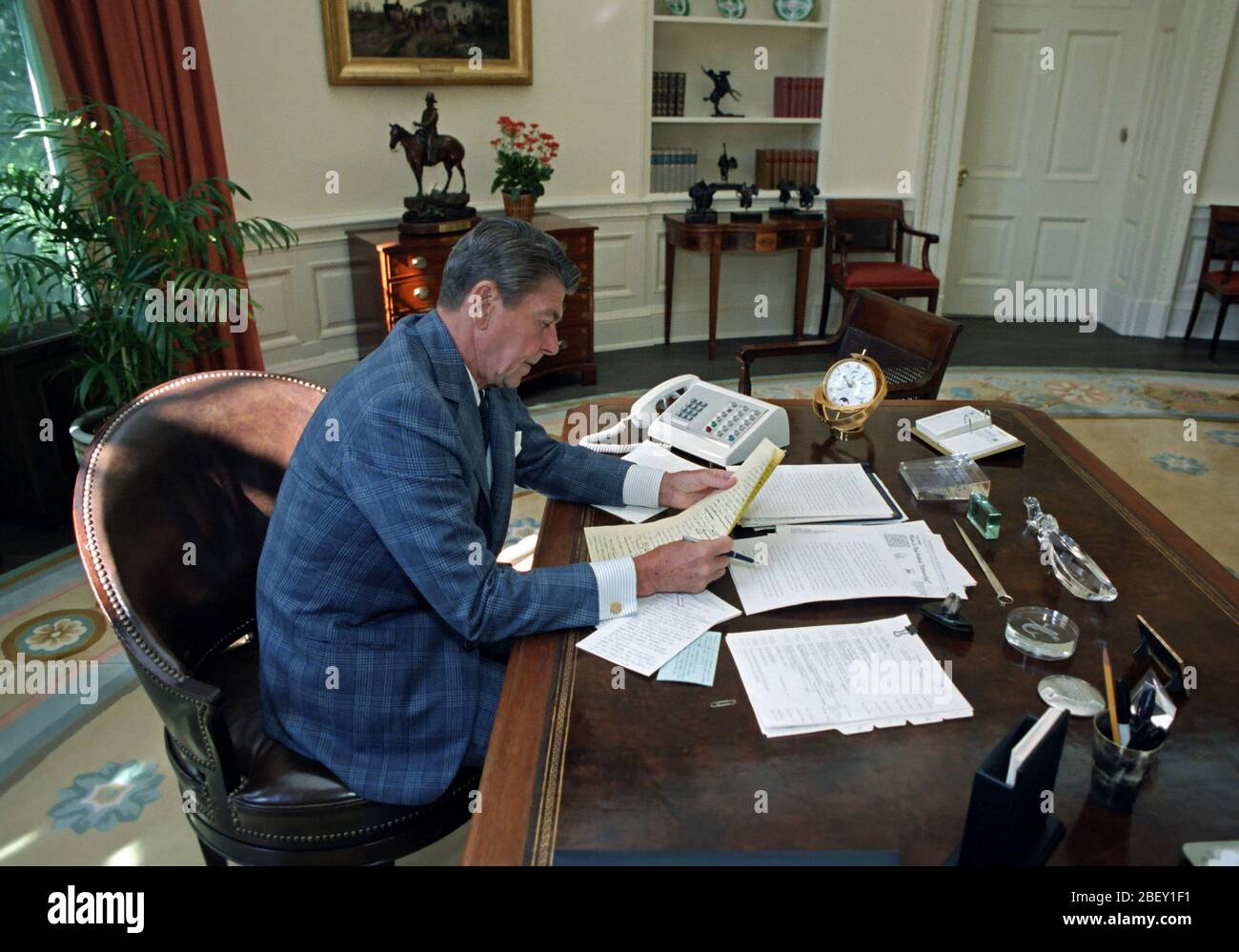 9/24/1981 President Reagan in the Oval Office Working on upcoming speech to the nation Stock Photo