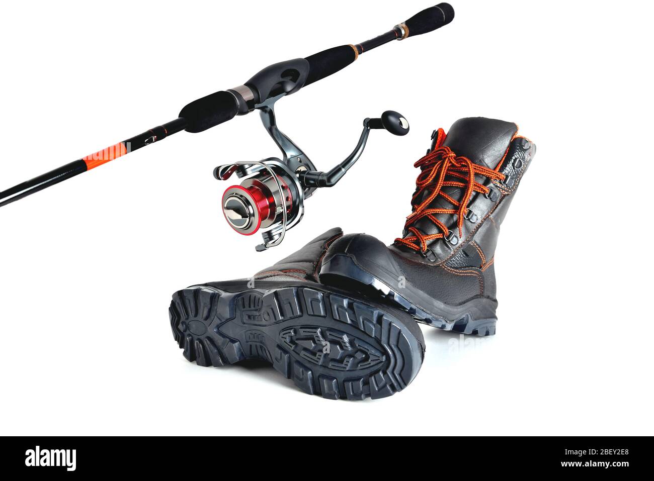 Spinning with a reel and off-road shoes with orange laces on a white background, isolate Stock Photo