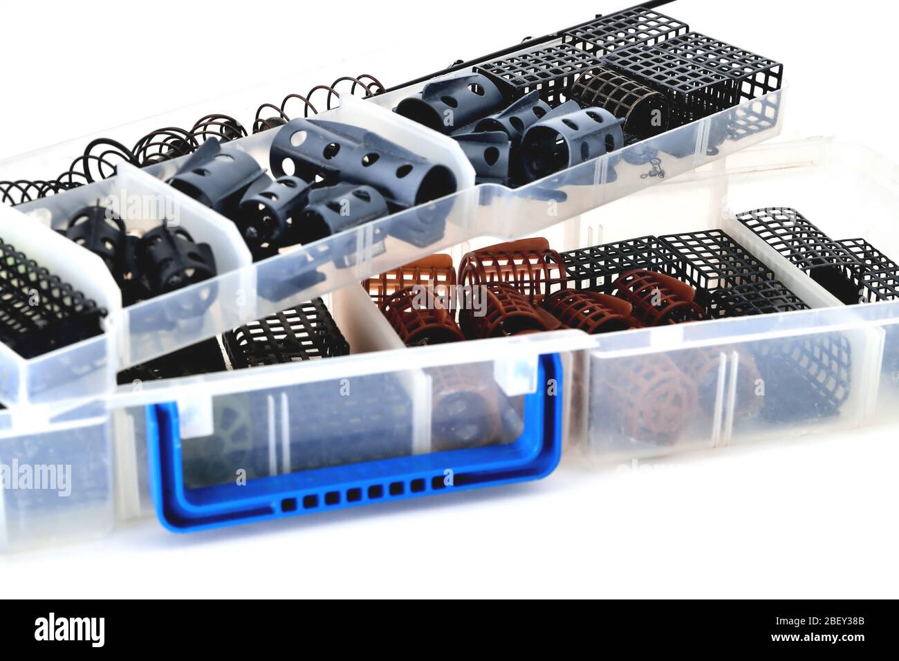Feeder troughs of different colors and sizes in a plastic box for accessory close-up Stock Photo