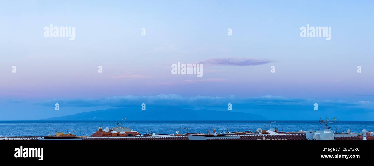 Panoramic view over the rooftops to La Gomera, pre dawn light, Playa San Juan, Tenerife, Canary Islands, Spain Stock Photo