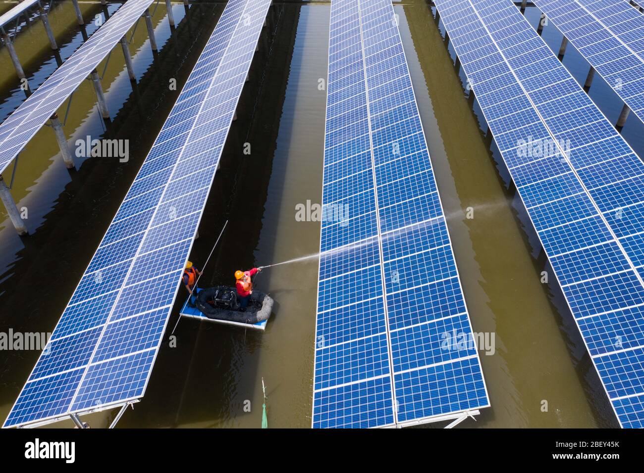 (200416) -- CHANGXING, April 16, 2020 (Xinhua) -- Aerial photo taken on April 16, 2020 shows workers on boat inspecting the operation of photovoltaic panels and cleaning photovoltaic modules at a fish farm in Gulong Village of Changxing County, east China's Zhejiang Province.  The fish farm, covering an area of 500 mu (about 33.3 hectares), is used to raise fish and, at the same time, to generate electricity after photovoltaic panels are installed on its surface.    Generating more than 20 million kilowatt-hour electricity annually, the application of photovoltaic panels can create a revenue o Stock Photo