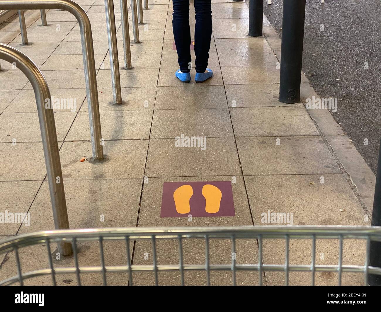 Queuing in line outside a supermarket Stock Photo