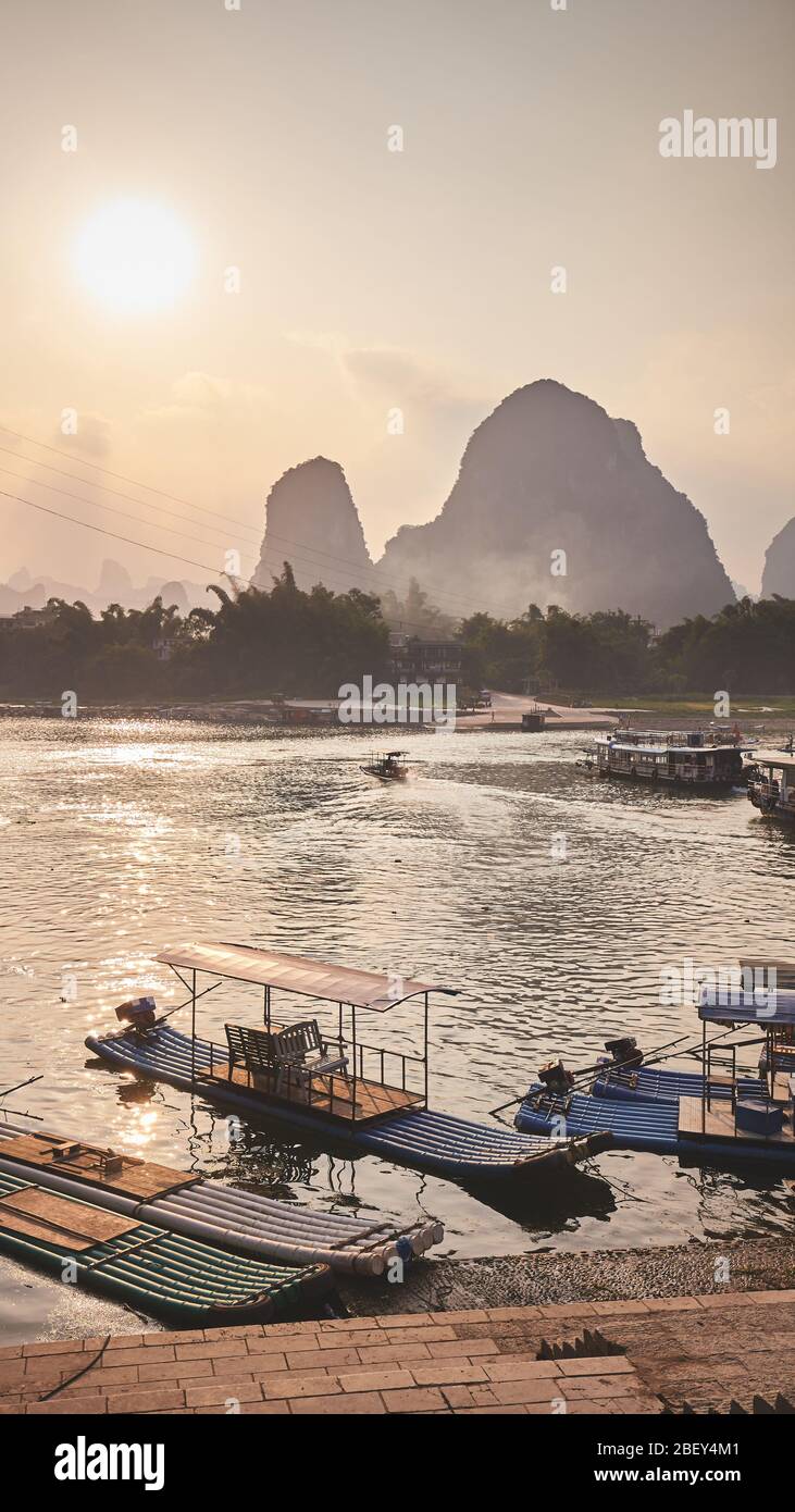 Bamboo rafts at Li River bank in Xingping at sunset, color toning applied, China. Stock Photo