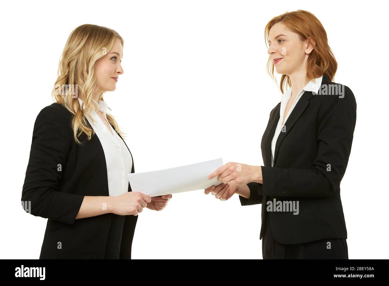 Agreement between two beautiful businesswomen. Paper, contract. Stock Photo