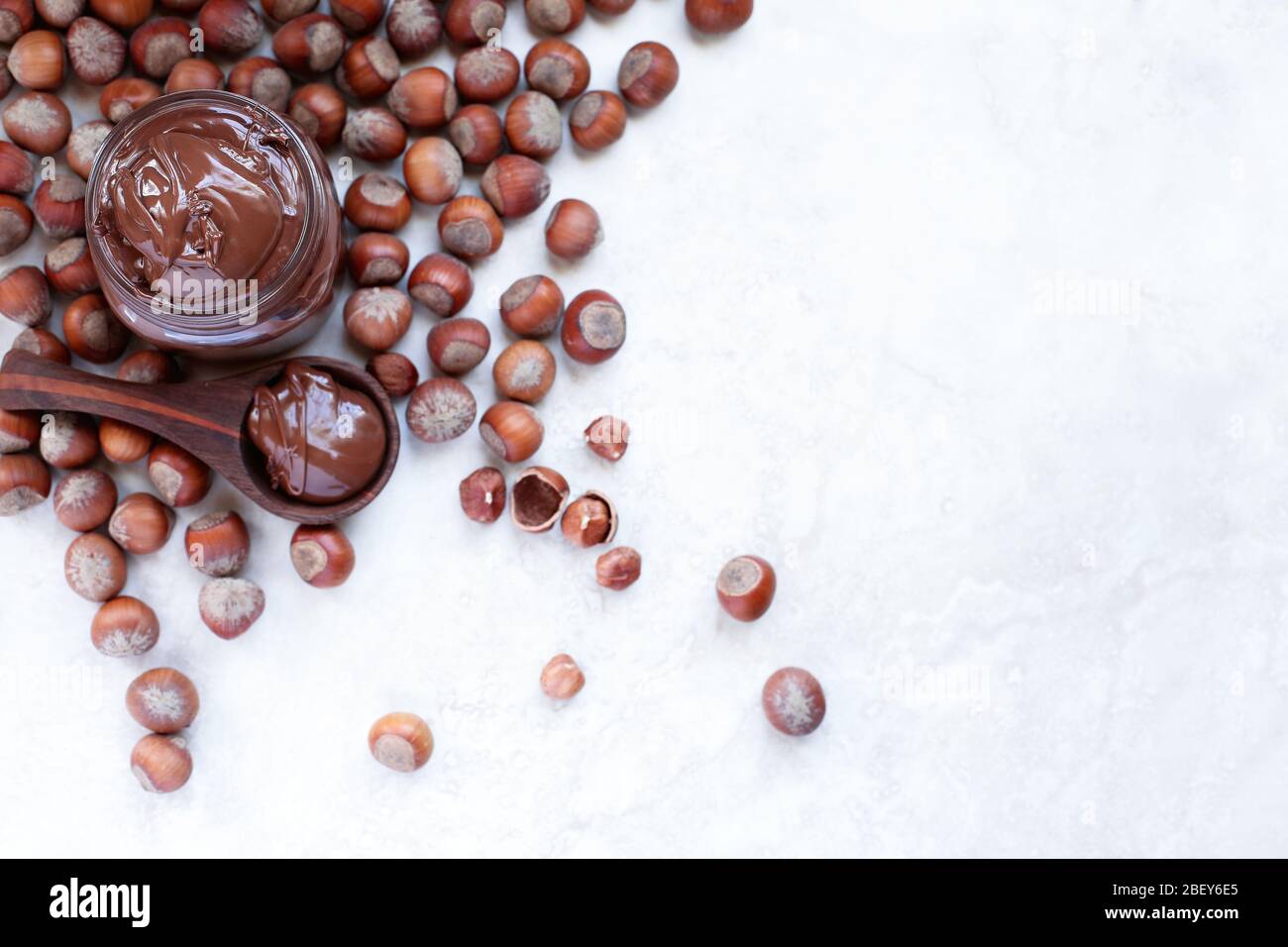 Fresh made homemade chocolate and hazelnut spread over a a white marble backdrop. Extreme shallow depth of field with blurred background. Stock Photo