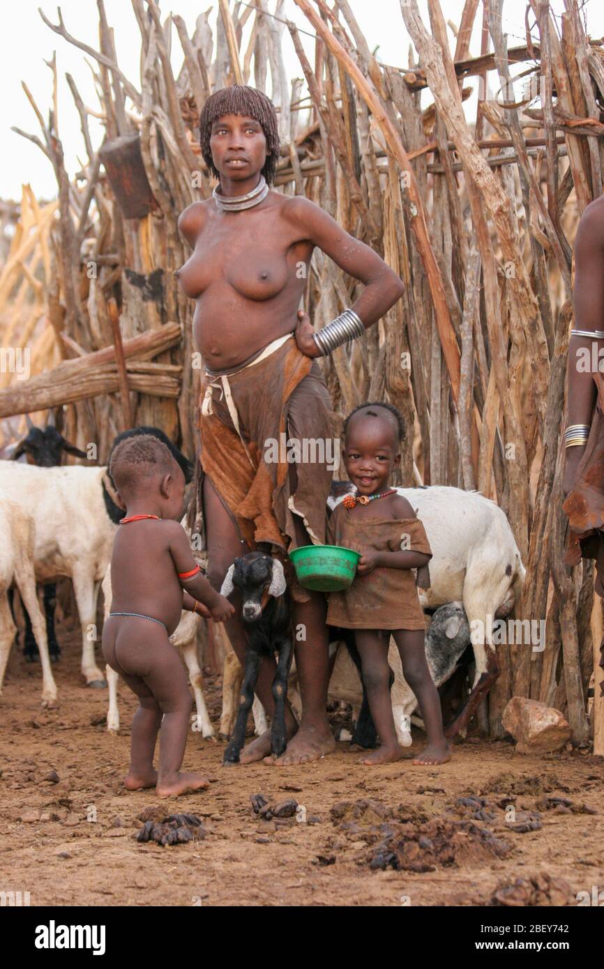 Hamer woman with a herd of goats Photographed in the Omo River Valley, Ethiopia Stock Photo