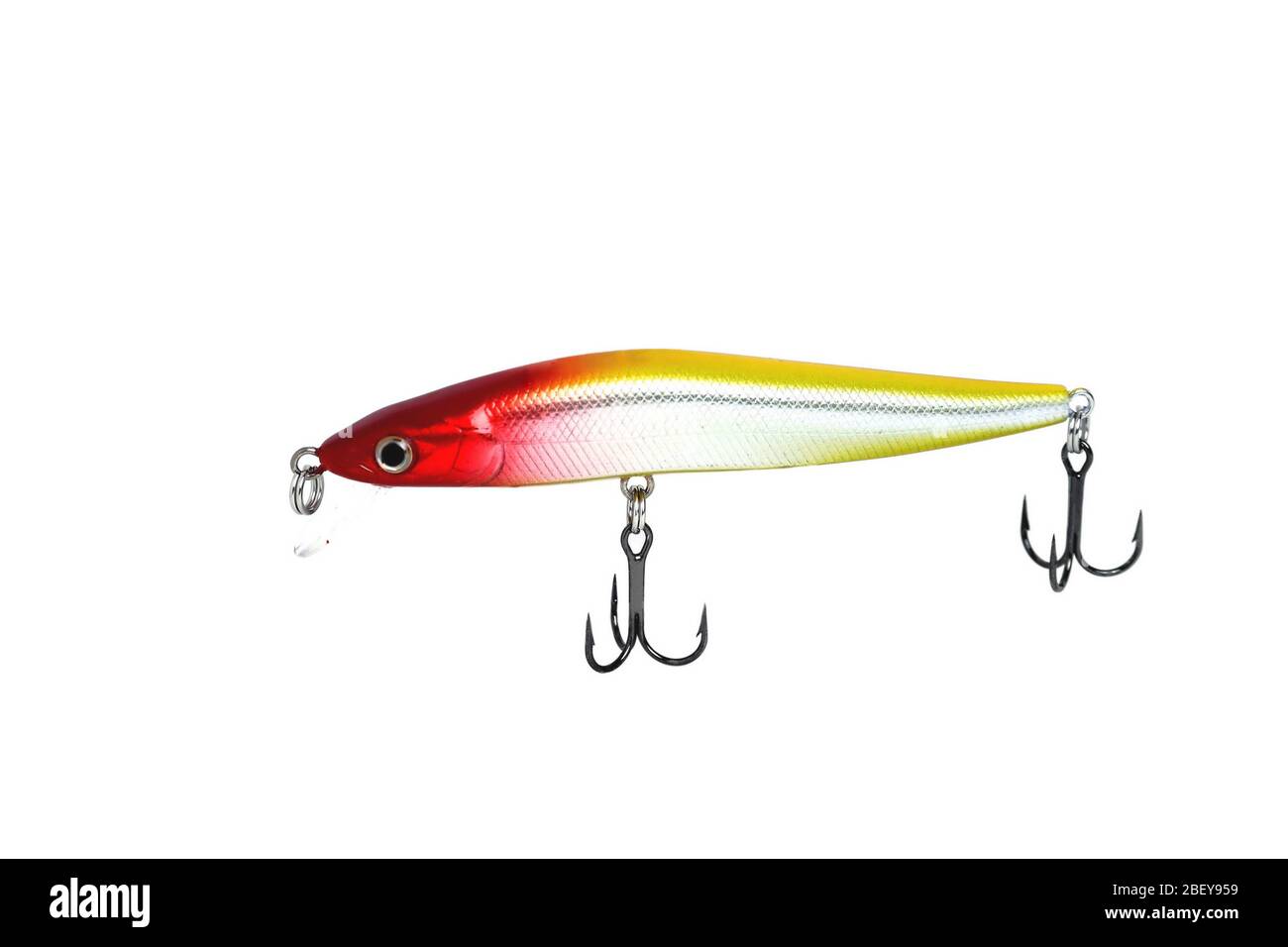 Fishing wobbler with red head, yellow back and white belly. Close-up on a white background. Stock Photo