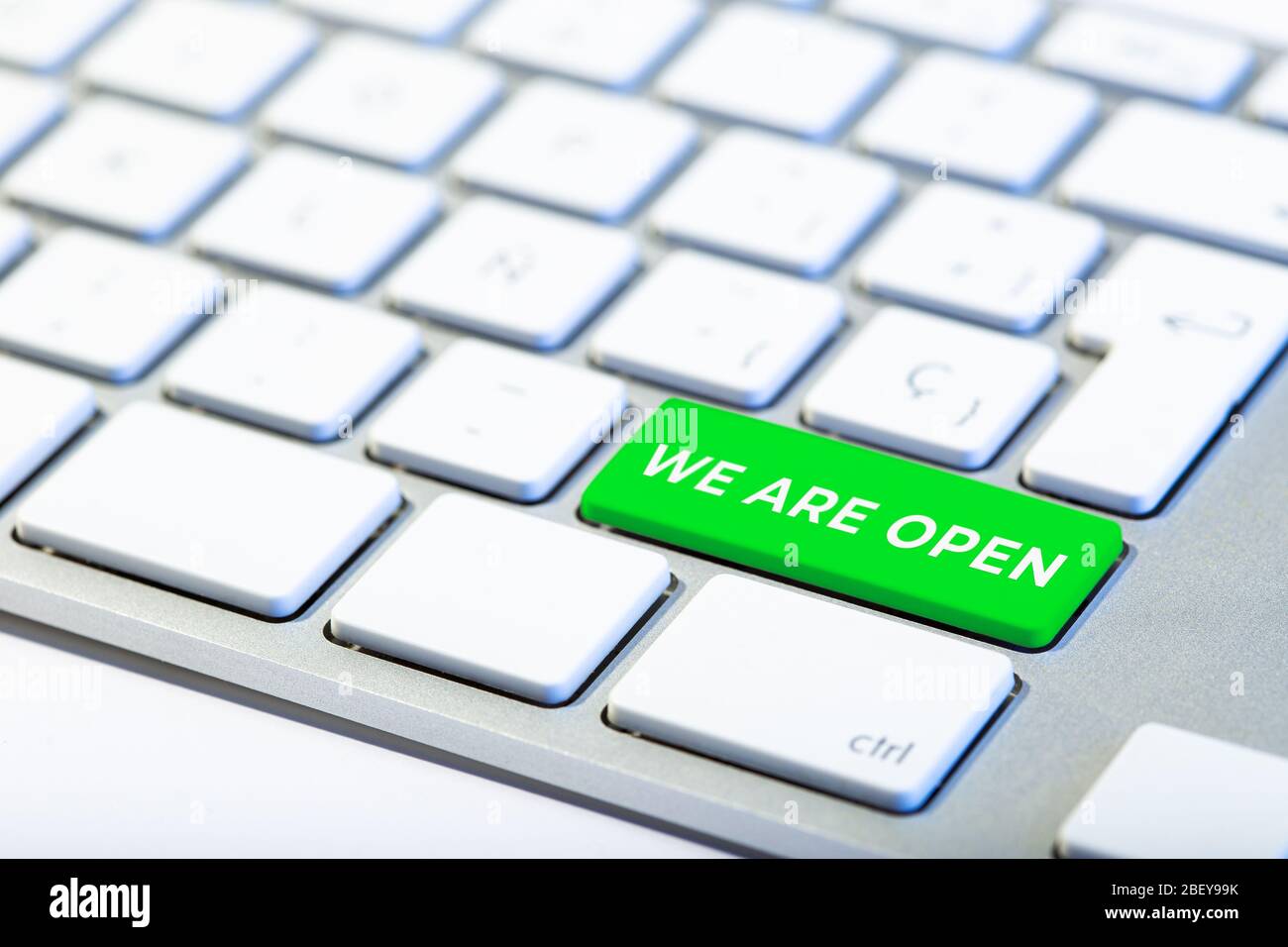 We are open concept. Keyboard with green key and text Stock Photo