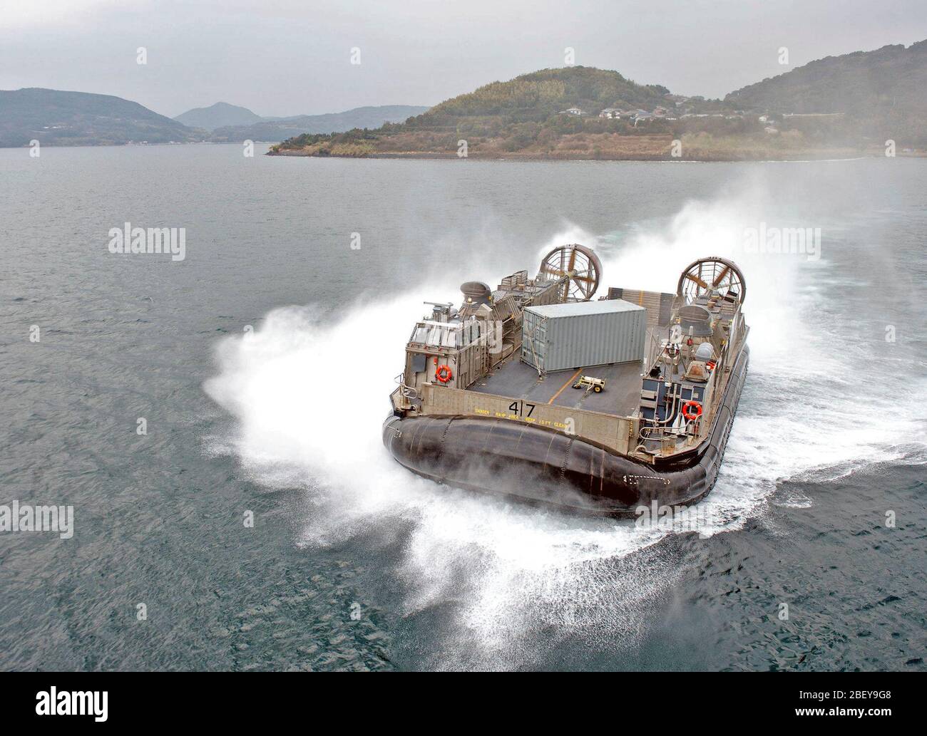 SASEBO, Japan (Jan. 24, 2013) A landing craft air cushion (LCAC) approaches the stern gate of the amphibious assault ship USS Bonhomme Richard (LHD 6), joining it on a scheduled deployment. The Bonhomme Richard Amphibious Ready Group is on deployment in the U. S. 7th Fleet area of operations and will take part in amphibious integration training (AIT), and certification exercise (CERTEX) and will participate in the annual multi-national combined joint training exercise Cobra Gold. Stock Photo