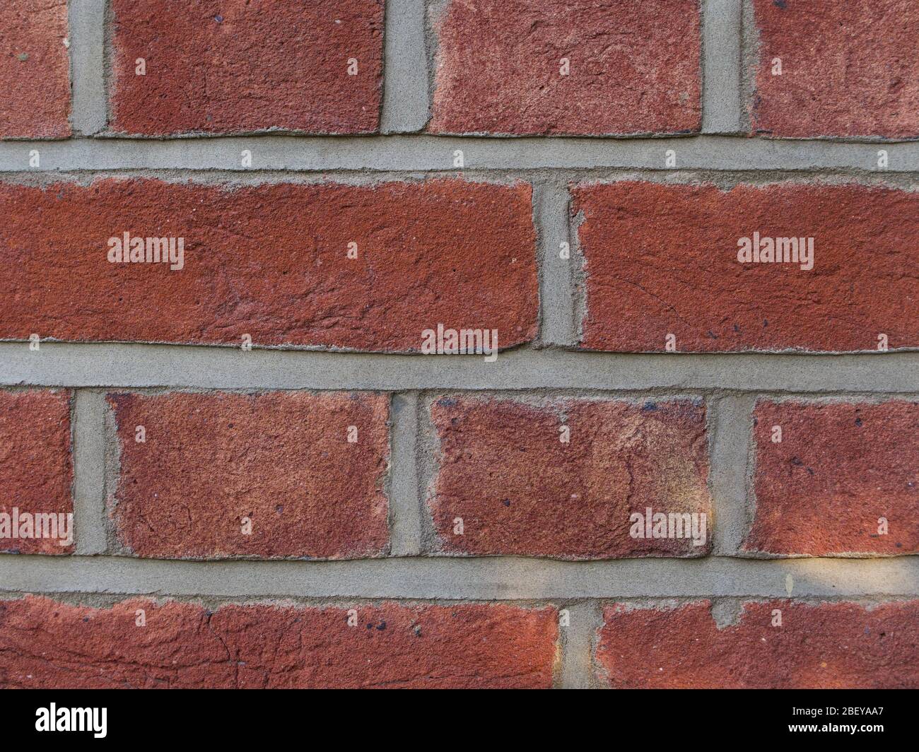 Close up of coarse red brickwork with grey mortar Stock Photo Alamy