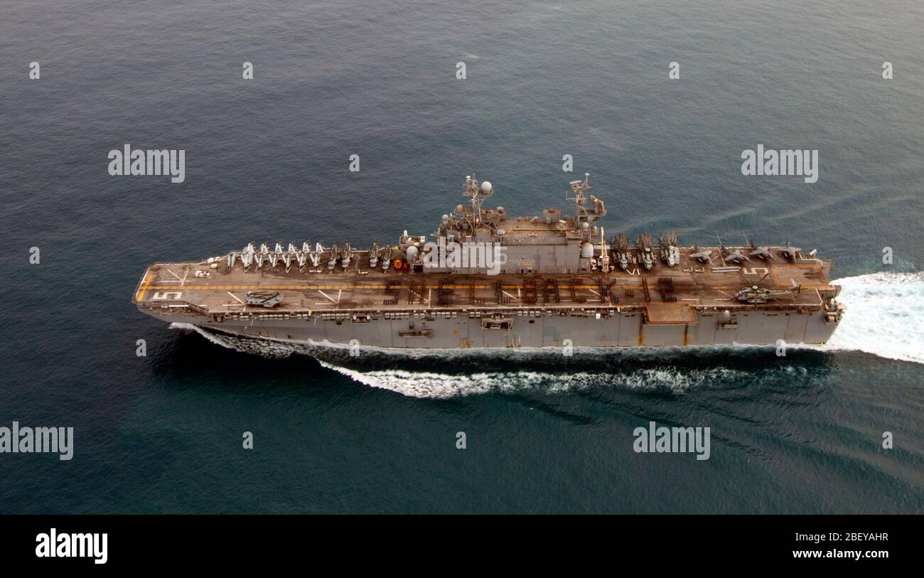 (Oct. 20, 2012) Sailors and Marines aboard the amphibious assault ship USS Peleliu (LHA 5) spell out SHELLBACK-12 while in formation in honor of those who crossed the equator for the first time. Peleliu is the flagship for the Peleliu Amphibious Ready Group on deployment with the amphibious transport dock ship USS Green Bay (LPD 20) and the amphibious dock landing ship USS Rushmore (LSD 47), with the 15th Marine Expeditionary Unit embarked throughout the three ships. Stock Photo