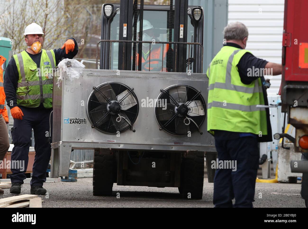 A refrigeration unit is removed from a lorry as work continues at the