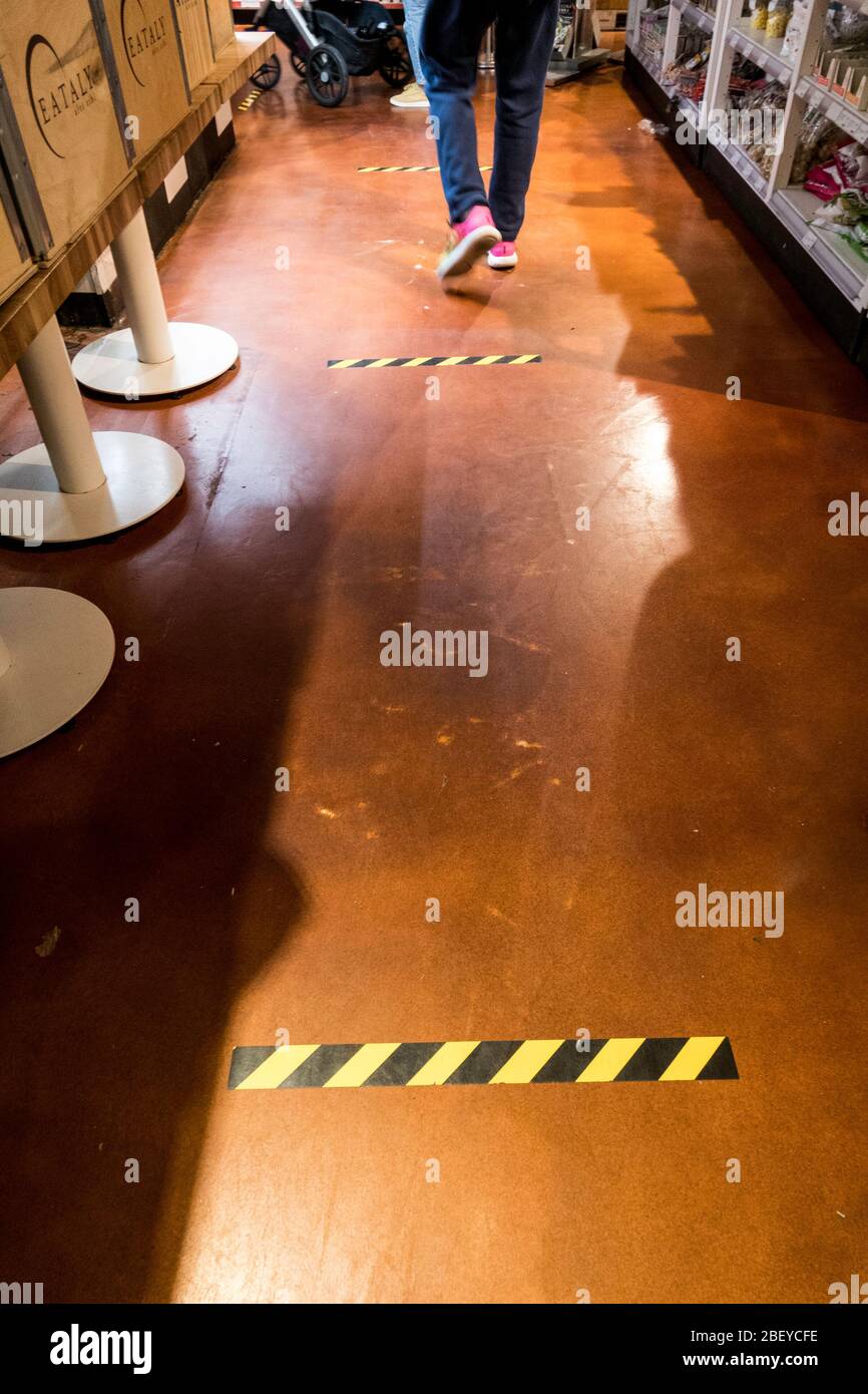 Social Distancing Markers in the aisle at the Eataly marketplace, April 2020, New York City, USA Stock Photo