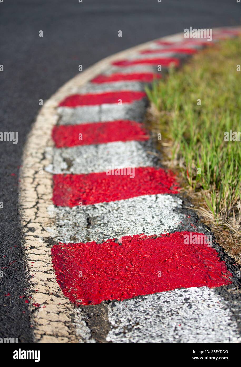 Red and white painted race kerbs at carting race track Stock Photo