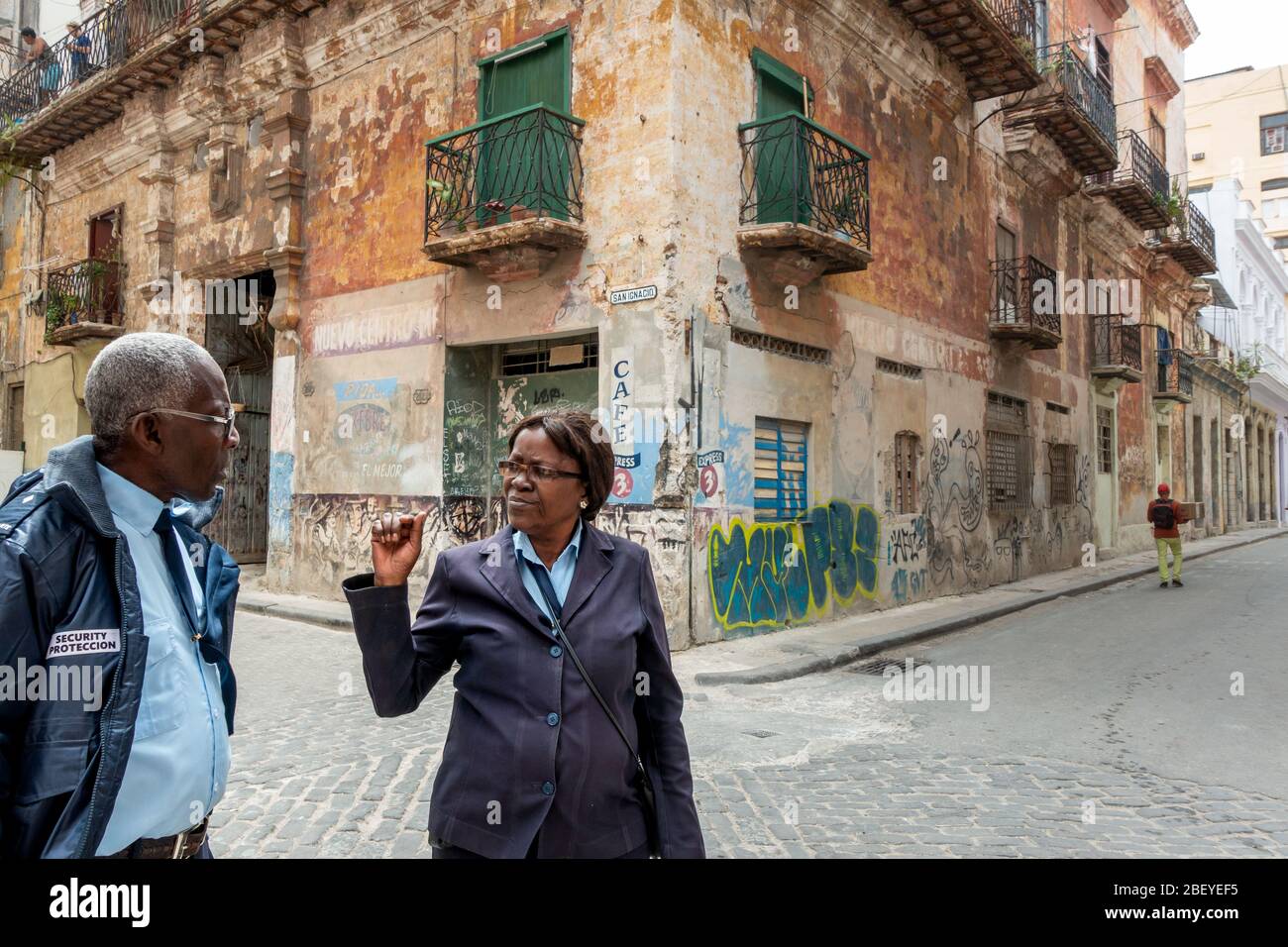 Two CVP people ( 'Cuerpo de Vigilancia y Protección'), or security guards, talking on Calle San Ignacio, Havana old town, Cuba Stock Photo