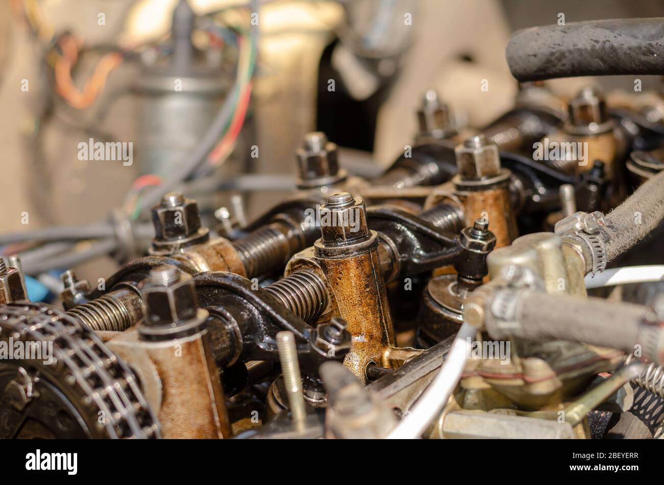 The engine compartment of a car closeup. Detailed shot of a carburetor
