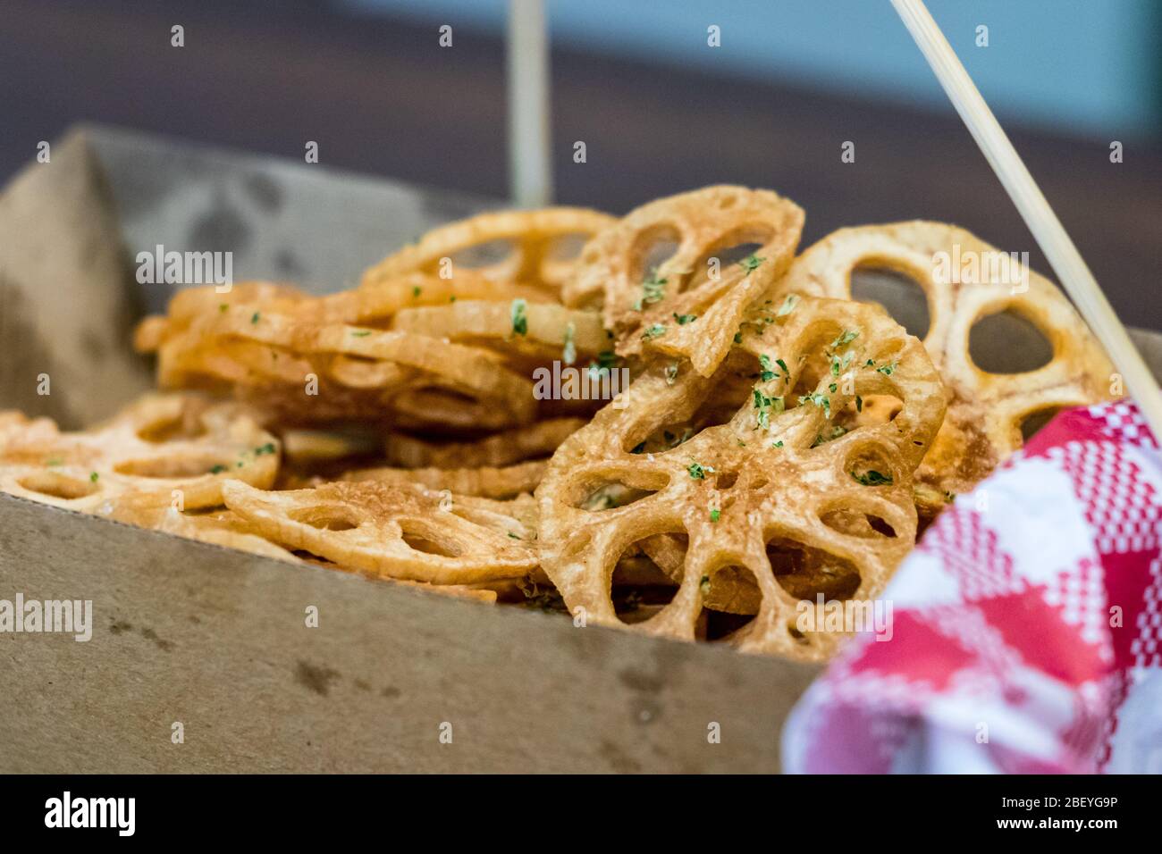 Close-up of a serving size of Lotus Root fried chips on a cardboard box Stock Photo