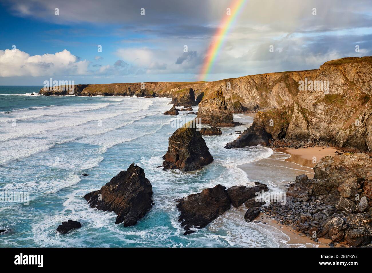 Rainbow over the dramatic coastline at Bedruthan Steps Stock Photo