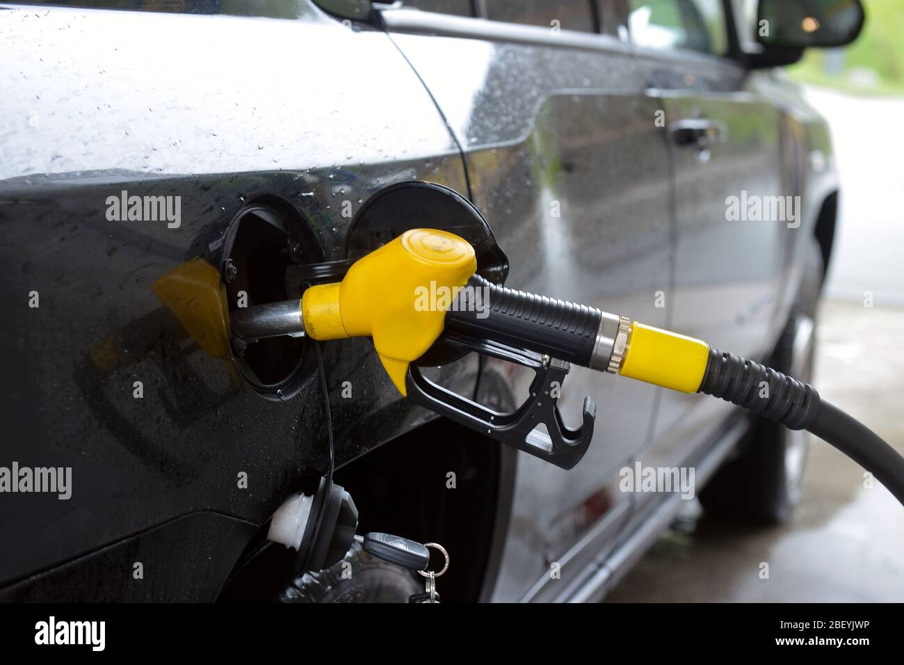 refilling up gas tank of the car with green eco fuel on a filling station Stock Photo