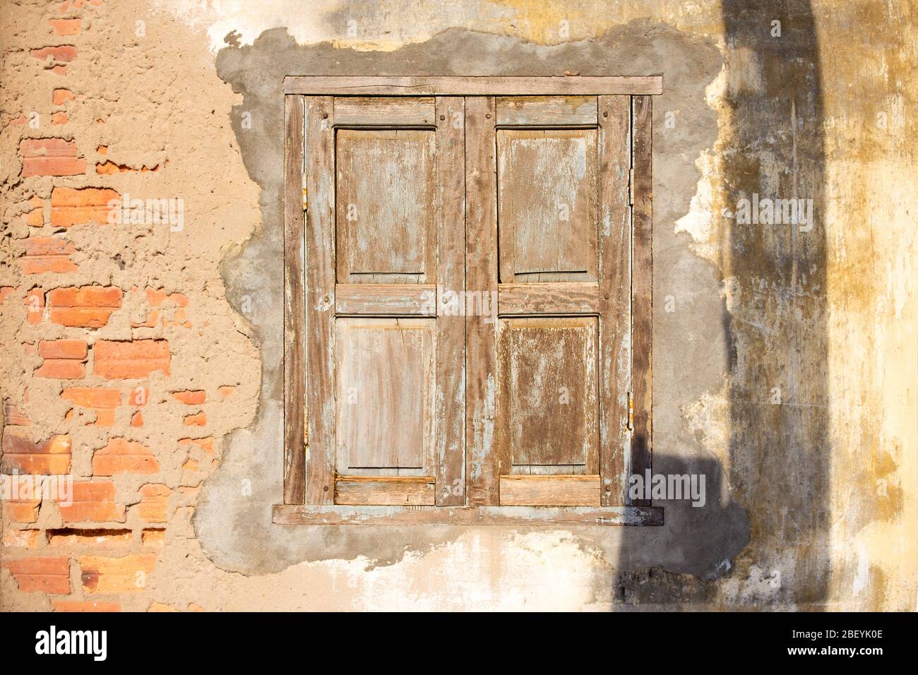 A closed weathered wooden shutter window. Stock Photo