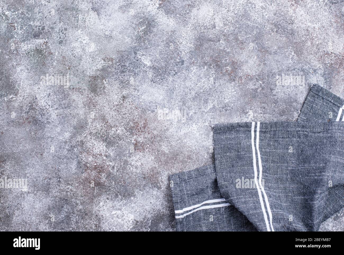 Linen napkin or towel on grey kitchen table Stock Photo