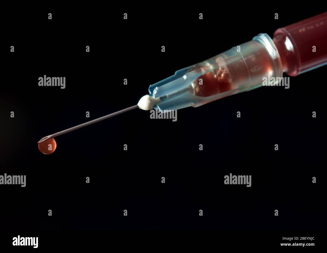 Syringe, injection needle on black background Stock Photo - Alamy