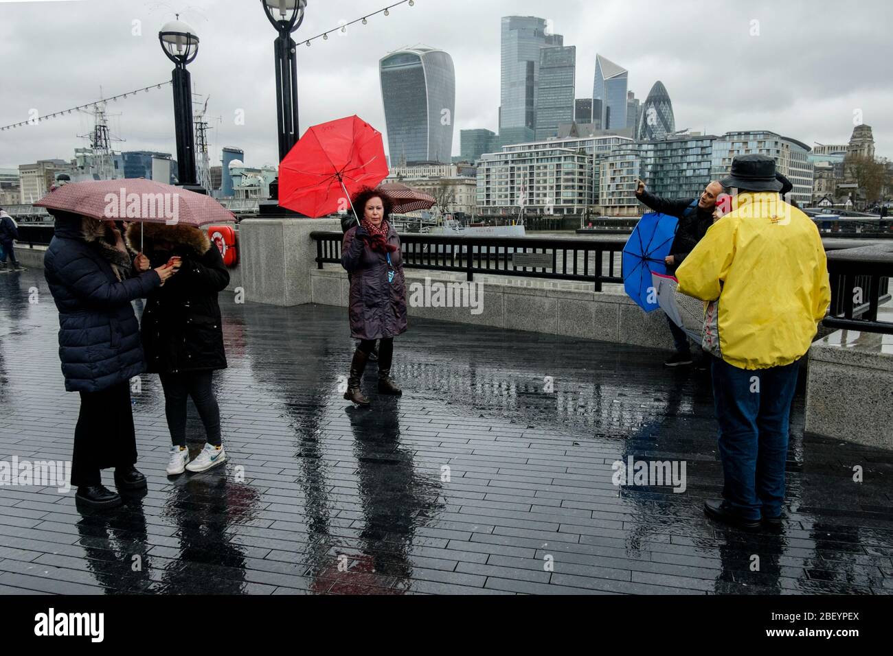 Tourists in London during rain downpour. Stock Photo