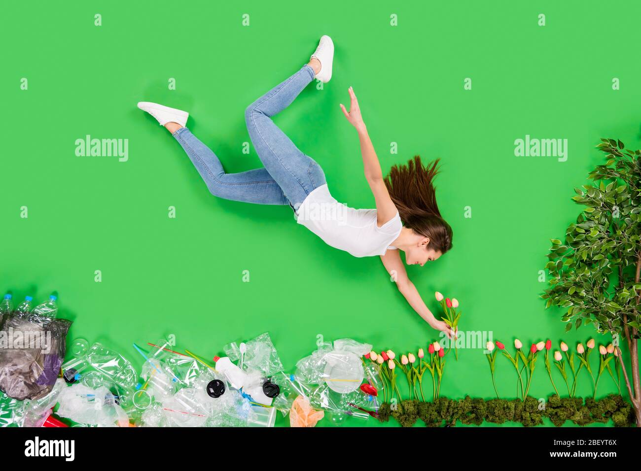 Full length high angle flat lay photo responsible citizen growing flowers taking care of nature sorting plastic products support against pollution Stock Photo