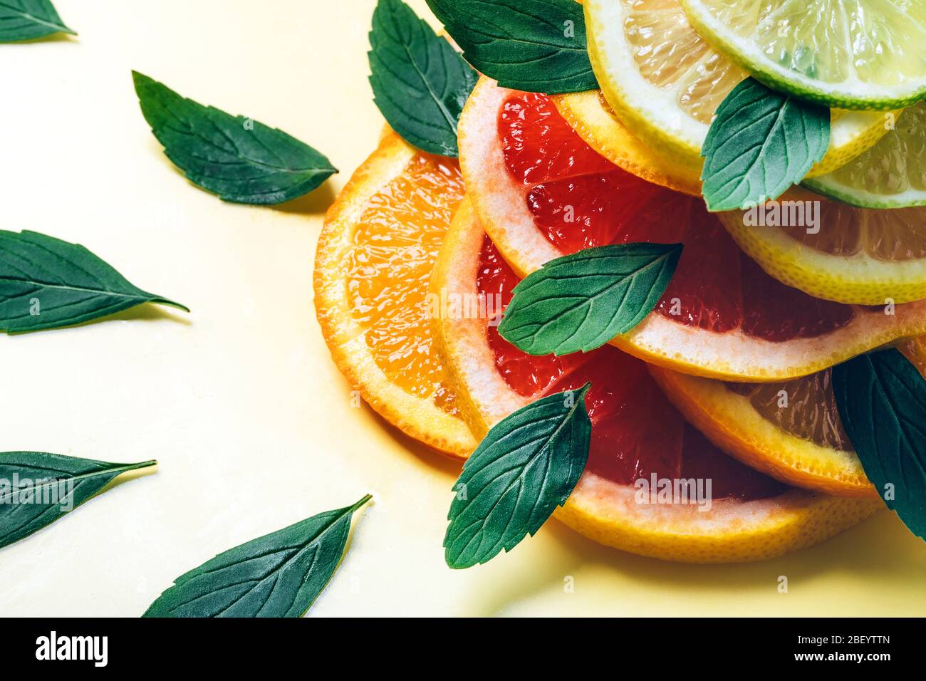 Citrus lemon, lime, orange and grapefruit slices and mint leaves in ...