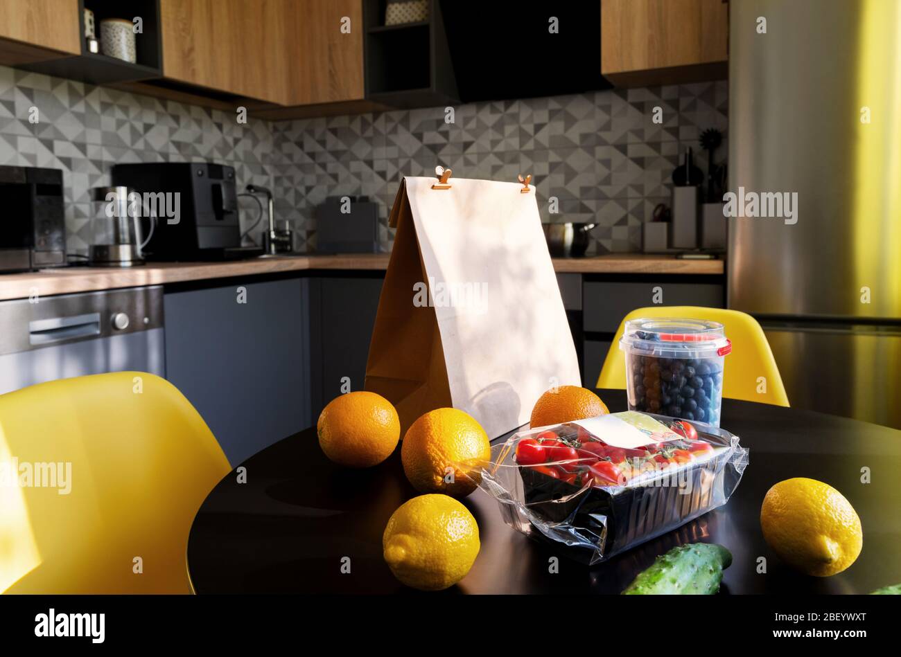 Bag with different food fruits and vegetables on modern kitchen Stock Photo