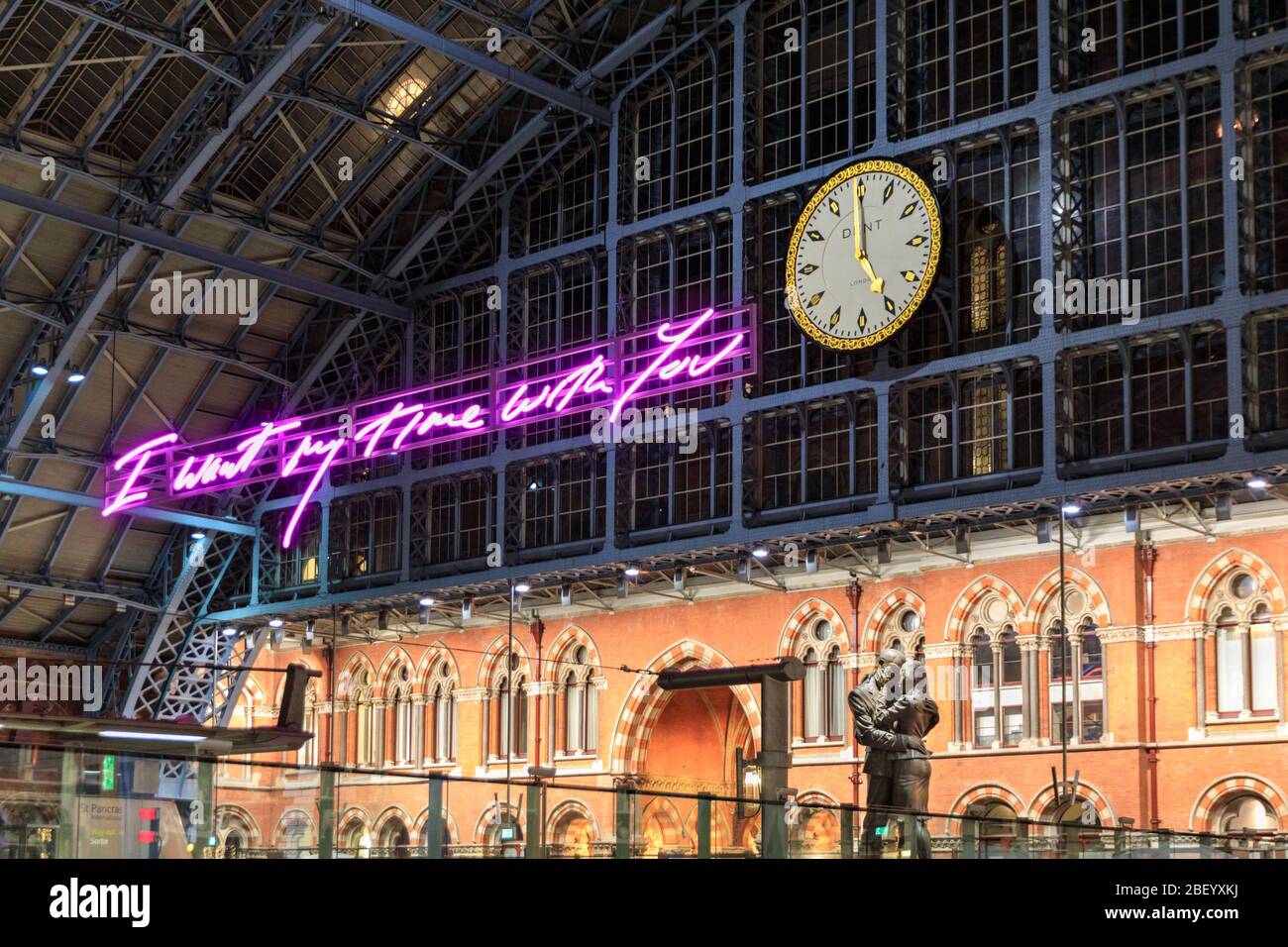 'I Want My Time With You' neon art light installation by Tracy Enim next to the concourse clock and 'Meeting Place' bronze sculpture by Paul Day,  St. Stock Photo
