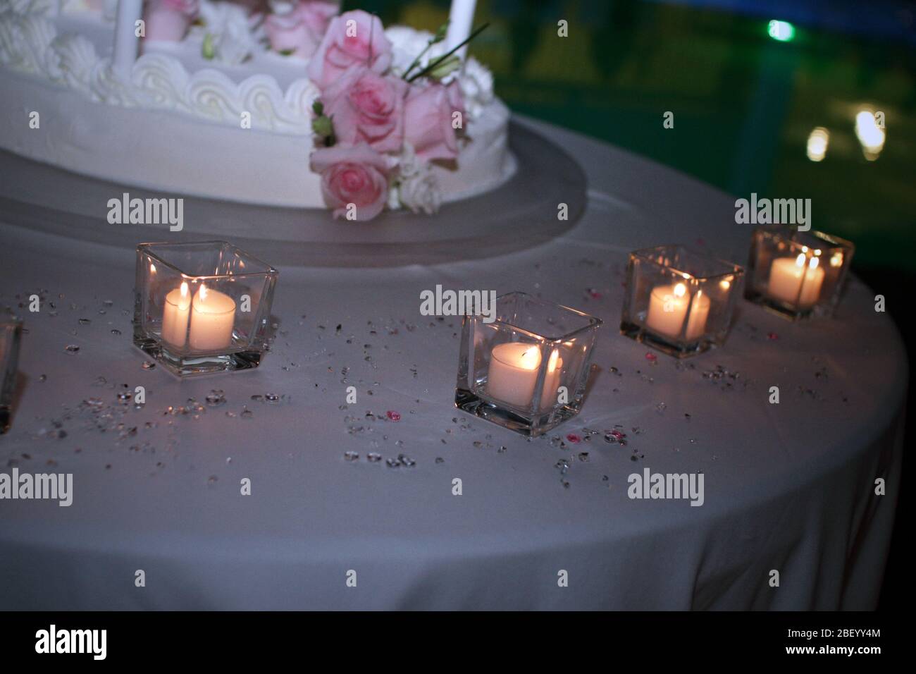 Wedding cake with candles and roses Stock Photo - Alamy