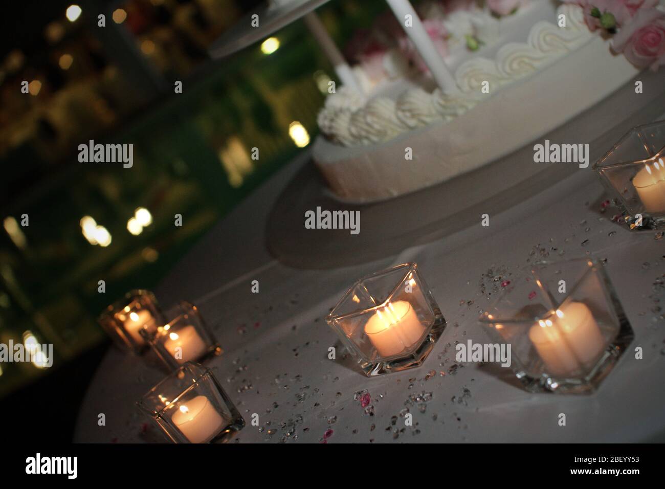 Wedding cake with candles and roses Stock Photo - Alamy
