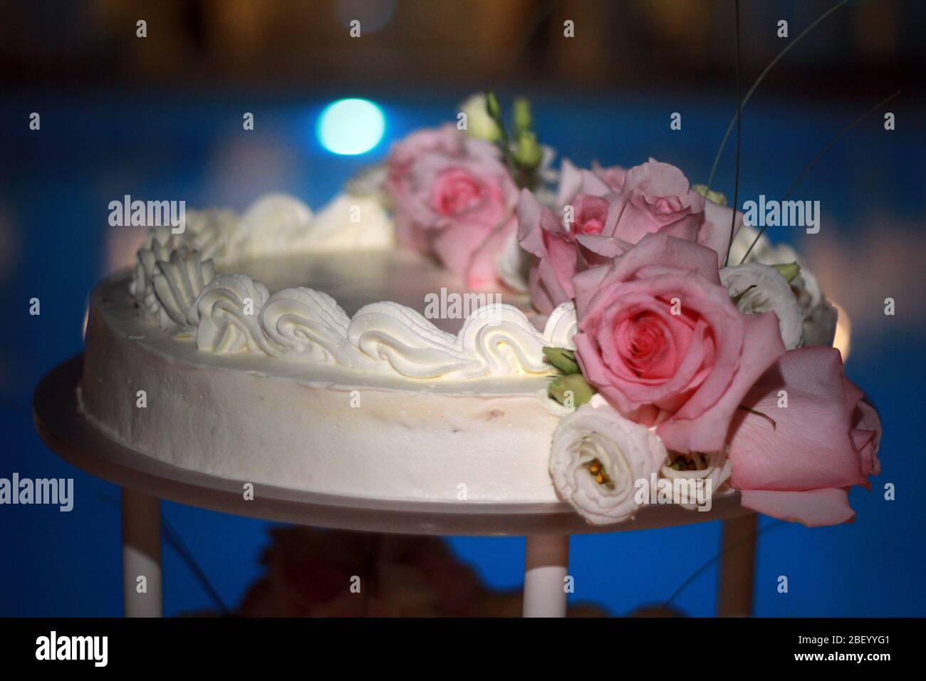 Wedding cake with candles and roses Stock Photo - Alamy