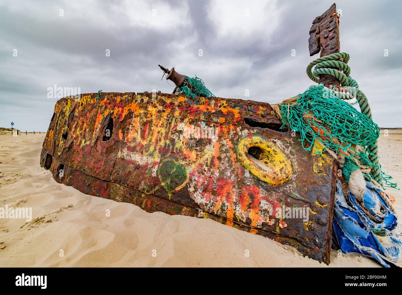 Rusty shipwreck with grafiti on island of Norderney, germany Stock Photo