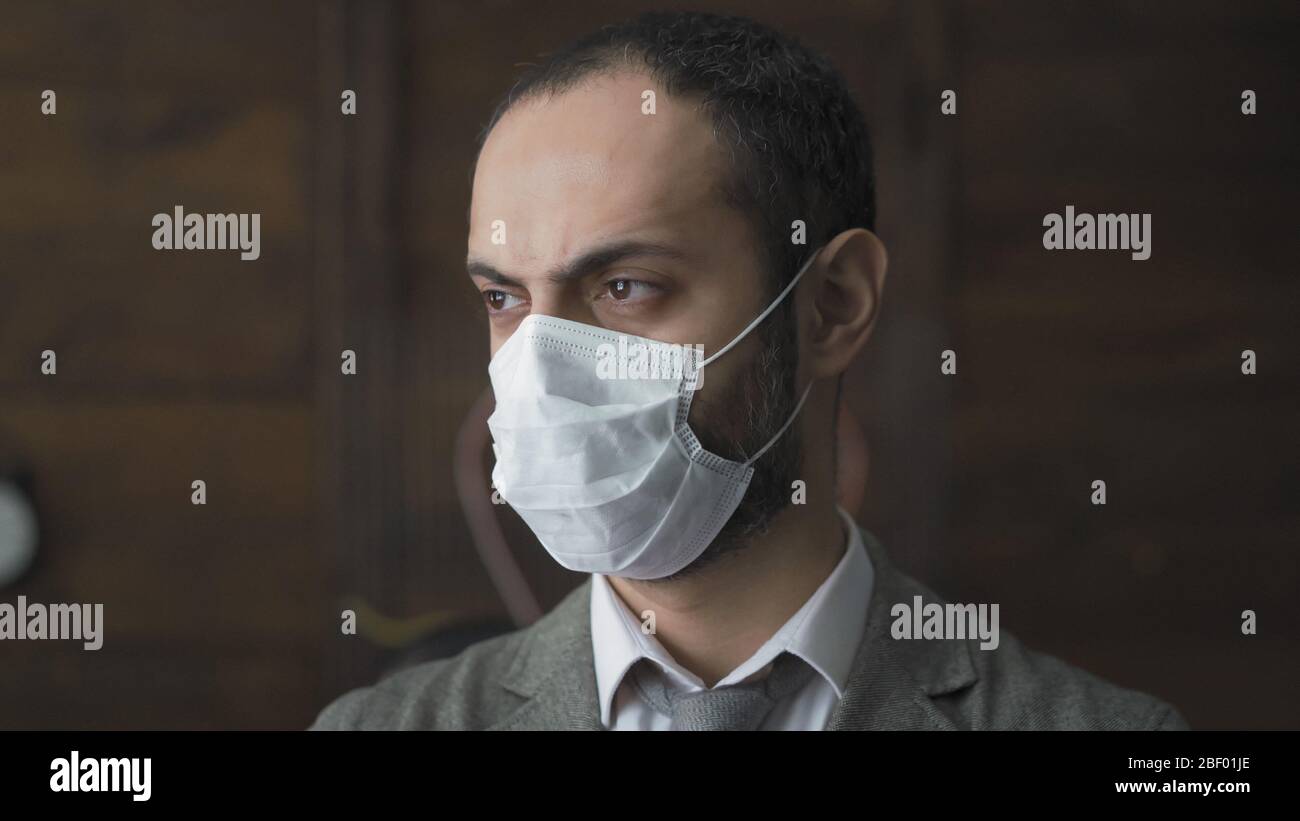 Businessman In Mask Is Sad In Isolation Durind Quarantine Stock Photo