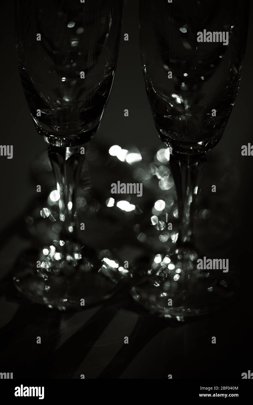 Champagne glasses made of crystal illuminated in a dark room. Concept : artistic minimalism. Stock Photo