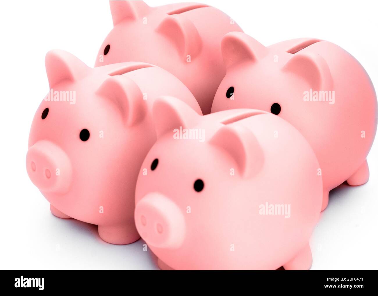 . Four pink piggy banks isolated against white background Stock Photo
