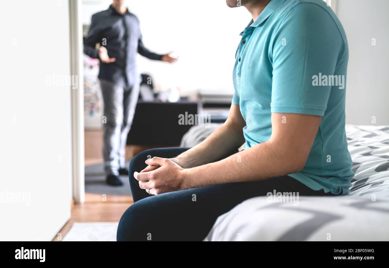 Fighting gay couple. Angry and sad man with crisis and stress. Brothers in argument or friends in conflict.  Jealous unhappy guy having issues. Stock Photo